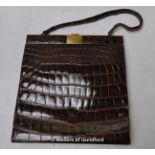 A 1950's crocodile skin handbag by Bagcraft, Sackville model, with suede interior.