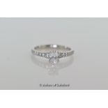 Single stone diamond ring, oval cut diamond weighing 0.72ct, with round brilliant cut diamond set to