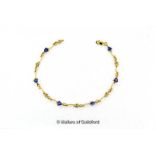 Tanzanite and diamond line bracelet, six trilliant cut tanzanites separated by wavy gold bars each