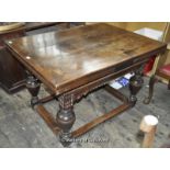 A Victorian oak drawleaf table, the plain top over shaped apron, raised on four bulbous vase