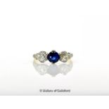 Three stone sapphire and diamond ring, a central round cut sapphire weighing an estimated 0.55ct,