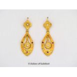 Pair of drop earrings, each earring a pear shaped design set with three cabochon rubies, and a