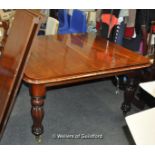 A Victorian mahogany extending dining table with two extra leaves, rounded corners and raised on