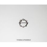 Diamond set brooch, the circular brooch set with eight old cut diamonds, mounted in white metal