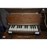 A charming scratch-made xylophone encased as an oak upright piano with keys. 40x23x30cm