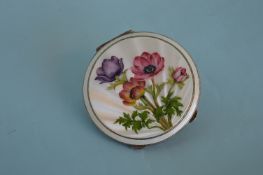 An attractive enamelled compact decorated with flo