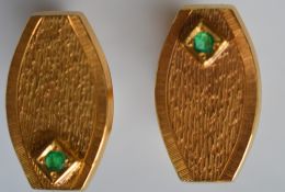 A heavy pair of 22 carat emerald set cuff links. A