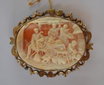 A large oval cameo of a village scene with scroll