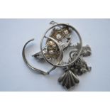 A bag containing silver and other brooches, bangle