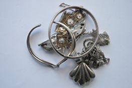 A bag containing silver and other brooches, bangle