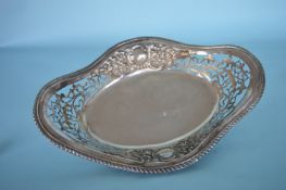 A large oval boat shaped bread dish with embossed