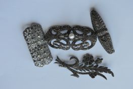 Four silver and marcasite brooches. Est. £20 - £30