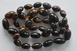 A long graduated string of amber beads. Approx. 48