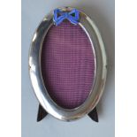 An oval plain picture frame with blue enamelled bo