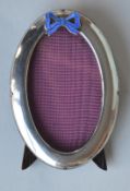 An oval plain picture frame with blue enamelled bo