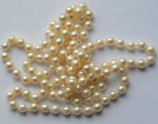 A long string of pearl beads. Est. £30 - £40.