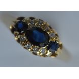 An 18 carat sapphire and diamond oval cluster ring