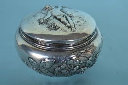 A good circular caddy decorated with winged infant