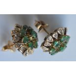 A pair of heavy gold emerald and diamond cluster e