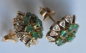 A pair of heavy gold emerald and diamond cluster e