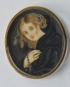 An oval miniature of a girl. Est. £20 - £30.
