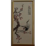 An Oriental sampler of a bird on a blossom branch.