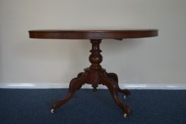 A mahogany pedestal table on turned supports. Est.