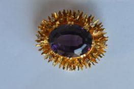 A heavy amethyst and diamond oval brooch in modern