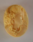 A good quality carved ivory cameo of a lady in hig