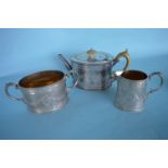 An attractive engraved three piece tea service wit