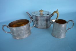 An attractive engraved three piece tea service wit