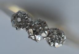An attractive diamond three stone ring in 18 carat