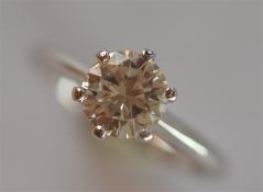 A diamond single stone ring. The brilliant cut sto