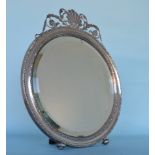 A large round dressing table mirror, the top decor