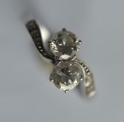 A small diamond and platinum crossover ring in cla