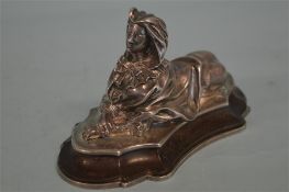 A heavy cast paperweight in the form of a westerni