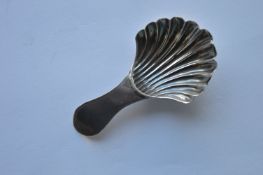 An early Georgian bright cut caddy spoon with flut