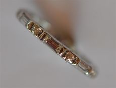 An 18 carat white gold full eternity ring. Est. £1