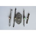 A collection of silver and marcisite brooches. Est