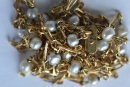 An 18 carat modern pearl mounted half guard chain