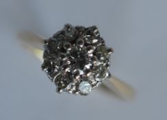 An 18 carat diamond circular cluster ring in two c