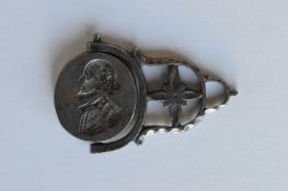 An antique steel spinning fob with loop top. Est.