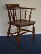 An oak smokers chair on turned supports. Est. £40