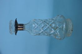 A silver mounted cut glass decanter with removable