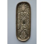 A small oval embossed pen tray with crimped rim. B