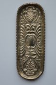 A small oval embossed pen tray with crimped rim. B