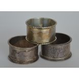 Three various napkin rings of engraved decoration.