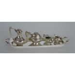 A small collectable silver miniature tea set on tr