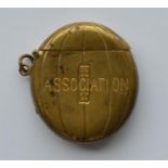 An oval brass vesta case in the form of a rugby ba