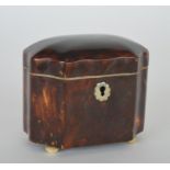 A tortoiseshell tea caddy on bun feet with hinged